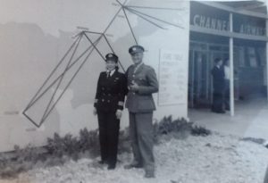 Jackie with husband Reg Moggridge outside Channel Airways building. Map on the wall shows the air routes flown by Channel Airways. Image courtesy of Candida Adkins.