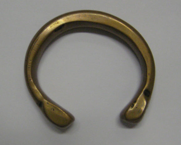 Gold ankle bracelet shaped like a bangle