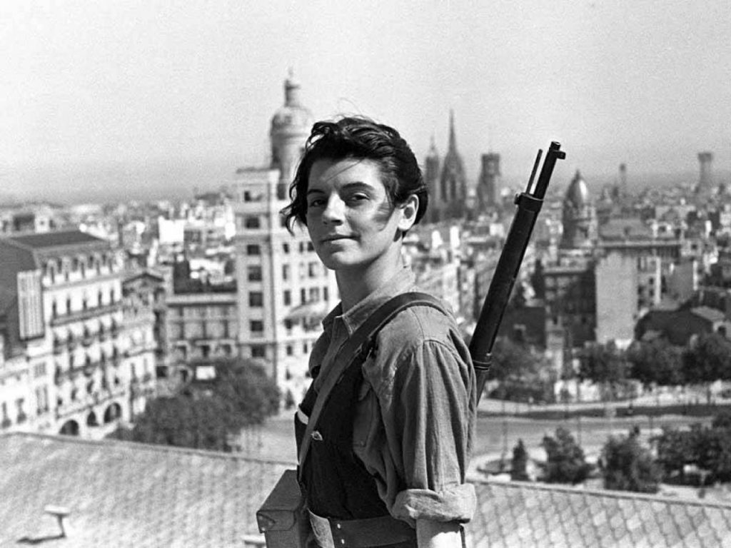 Marina Ginest√† holds a rifle and smiles on a rooftop in Barcelona in July 1936