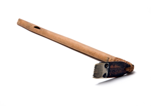 Wooden handle with brush on end for tattooing