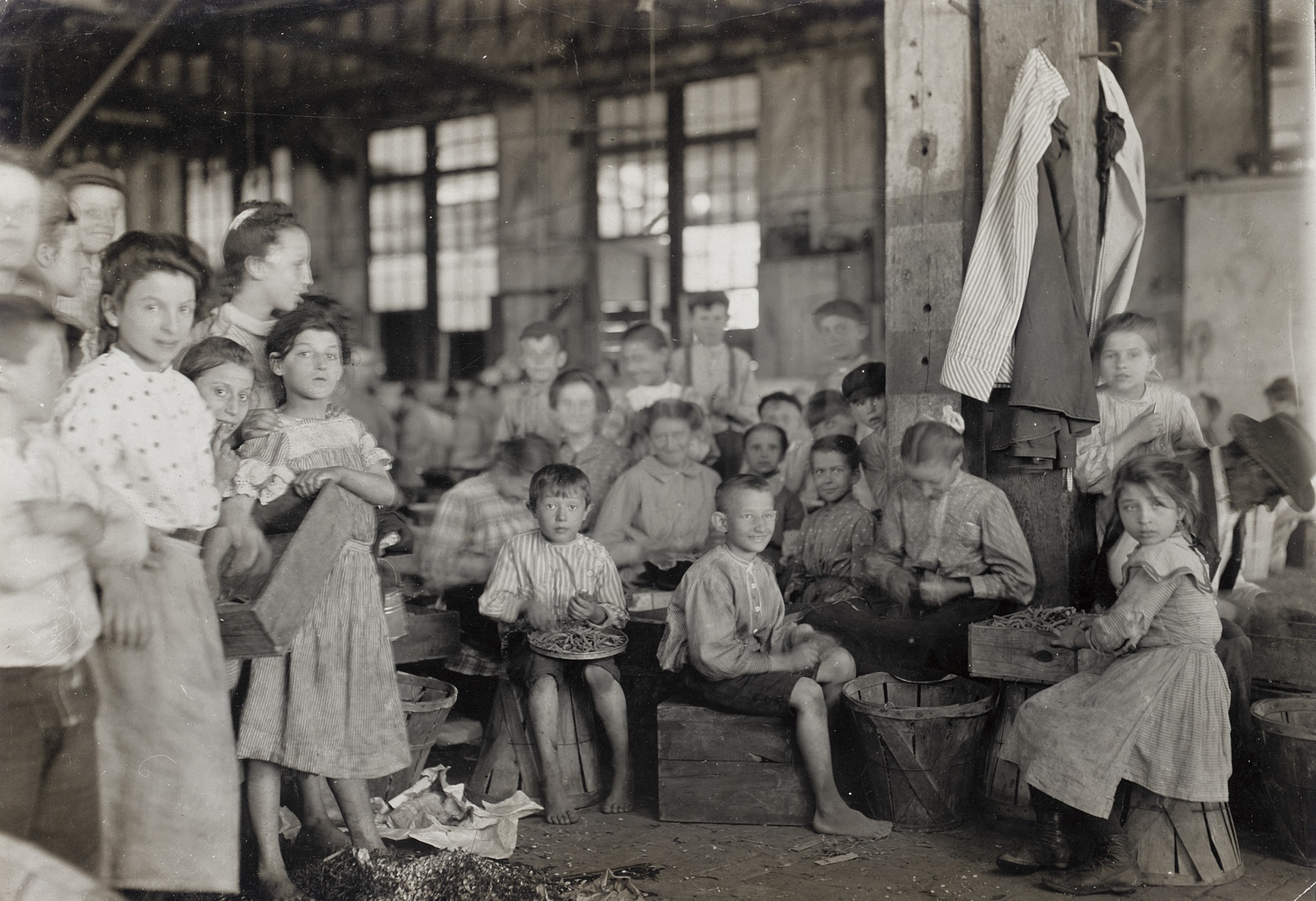 Young children in a factory pose for a group picture.