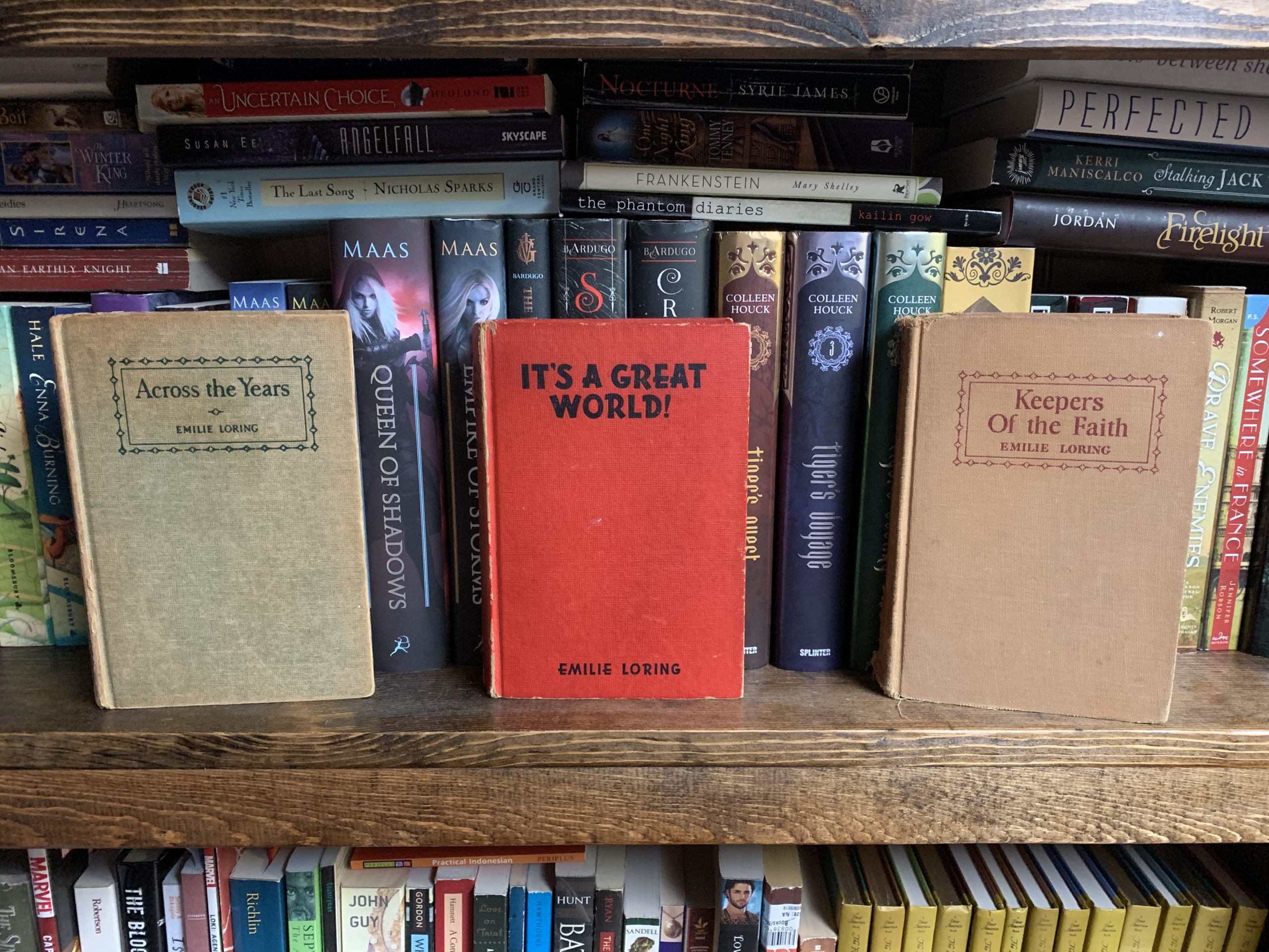 Three Emilie Loring novels on a bookshelf