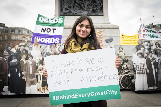 Amika George holds a sign calling for an end to period poverty.